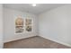 A room with carpet, white walls, and a large window overlooking a street at 411 Weather Ridge Ln # 45, Cary, NC 27513