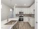 Modern kitchen with white cabinets, stainless steel appliances, and quartz countertops at 411 Weather Ridge Ln # 45, Cary, NC 27513