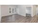 Open living room with wood-look flooring and glass doors to the outside at 411 Weather Ridge Ln # 45, Cary, NC 27513