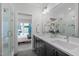 Modern bathroom with dual sink vanity, glass shower and view into bedroom at 5 Seawell Ave # 106, Raleigh, NC 27601