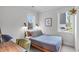 Cozy bedroom featuring natural light, neutral tones, and a comfortable bed with stylish decor at 5 Seawell Ave # 106, Raleigh, NC 27601