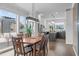 Elegant dining area with a large wooden table, comfortable seating, and a view into the modern kitchen at 5 Seawell Ave # 106, Raleigh, NC 27601