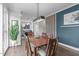 Bright dining room featuring hardwood floors, a modern light fixture, and seating for six, open to the kitchen at 5 Seawell Ave # 106, Raleigh, NC 27601