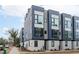 Modern townhome exterior featuring a striking design with large windows and a rooftop terrace at 5 Seawell Ave # 106, Raleigh, NC 27601
