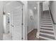 Bright hallway with staircase and multiple doors, providing access to different areas of the home at 5 Seawell Ave # 106, Raleigh, NC 27601