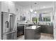Stylish kitchen featuring stainless steel appliances, white cabinets, and a gray island with countertop seating at 5 Seawell Ave # 106, Raleigh, NC 27601