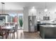 Open-concept kitchen featuring stainless steel appliances and a spacious dining area with hardwood floors at 5 Seawell Ave # 106, Raleigh, NC 27601