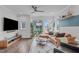 Cozy living room boasts large windows, sleek ceiling fan, and stylish furnishings, creating an inviting atmosphere at 5 Seawell Ave # 106, Raleigh, NC 27601