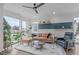 Bright living area featuring a comfortable leather sectional sofa and a view of the neighborhood at 5 Seawell Ave # 106, Raleigh, NC 27601
