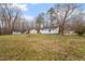 Large backyard features mature trees, a shed, and well-maintained lawn at 5144 Shield Cir, Raleigh, NC 27603