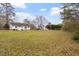 Spacious backyard features a well-maintained lawn and mature trees at 5144 Shield Cir, Raleigh, NC 27603