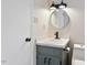 Charming bathroom with a vanity featuring updated fixtures, a round mirror, and modern lighting at 5144 Shield Cir, Raleigh, NC 27603