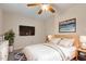 Cozy bedroom with plush carpet, neutral walls, wood accents, and a modern ceiling fan at 5144 Shield Cir, Raleigh, NC 27603