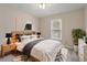 Comfortable bedroom decorated with plants, and stylish furnishings including a wooden headboard at 5144 Shield Cir, Raleigh, NC 27603