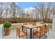 Cozy deck features a wooden table with six chairs and potted green plant at 5144 Shield Cir, Raleigh, NC 27603