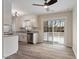 Open floorplan with stainless steel appliances, modern flooring and light fixtures, plus sliding doors to the deck at 5144 Shield Cir, Raleigh, NC 27603