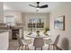 Inviting dining area features a modern light fixture, round white table, and sliding glass doors to the outdoor deck at 5144 Shield Cir, Raleigh, NC 27603