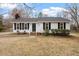 Charming single-story home featuring a well-maintained front yard and cozy front porch seating area at 5144 Shield Cir, Raleigh, NC 27603