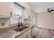 Tastefully updated kitchen with granite counters, stainless appliances, modern sink and fixtures at 5144 Shield Cir, Raleigh, NC 27603