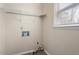 Neutral laundry room features a shelf and connection points for washer and dryer hookups at 5144 Shield Cir, Raleigh, NC 27603