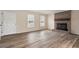 Bright living room featuring wood-look floors and brick fireplace at 5144 Shield Cir, Raleigh, NC 27603