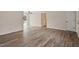 Open-concept living space with hardwood floors, door to the exterior and ceiling fan at 5144 Shield Cir, Raleigh, NC 27603