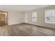 Empty room with hardwood floors, doors and natural light at 5144 Shield Cir, Raleigh, NC 27603