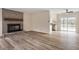 Spacious living room with wood-look flooring and a statement brick fireplace at 5144 Shield Cir, Raleigh, NC 27603
