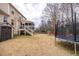 A spacious backyard is equipped with a swing set and a trampoline plus an external shed at 515 Littleport Dr, Rolesville, NC 27571
