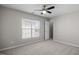 Bedroom with neutral gray carpet, walls, ceiling fan and a window with natural light at 515 Littleport Dr, Rolesville, NC 27571