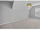 Bedroom with neutral gray carpet, walls, and a window offering natural light at 515 Littleport Dr, Rolesville, NC 27571