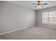 Bedroom featuring neutral carpet, walls, and a ceiling fan with natural light at 515 Littleport Dr, Rolesville, NC 27571