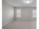 Large bedroom featuring neutral carpet, walls, and two windows offering natural light at 515 Littleport Dr, Rolesville, NC 27571