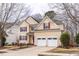 Charming two-story home featuring a two-car garage, red shutters, and a well-manicured lawn at 515 Littleport Dr, Rolesville, NC 27571