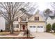 Charming two-story home featuring a two-car garage, red shutters, and a well-manicured lawn at 515 Littleport Dr, Rolesville, NC 27571