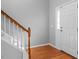 Bright foyer with hardwood floors, a staircase, and a front door with glass panels at 515 Littleport Dr, Rolesville, NC 27571