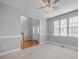Bright living room with neutral carpet, a ceiling fan, and large windows at 515 Littleport Dr, Rolesville, NC 27571