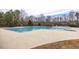 A large community pool with lap lanes and ample deck space surrounded by lush landscaping and mature trees at 515 Littleport Dr, Rolesville, NC 27571