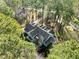 Aerial view of the home with well-manicured landscaping and mature trees at 5413 Leopards Bane Ct, Holly Springs, NC 27540