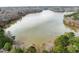 Aerial view showcasing the serene lake, bordered by lush trees, providing a private retreat at 5413 Leopards Bane Ct, Holly Springs, NC 27540