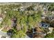 Aerial view of a residential neighborhood featuring mature trees at 5413 Leopards Bane Ct, Holly Springs, NC 27540
