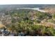 Scenic aerial view of a wooded neighborhood with lake access and beautiful natural surroundings at 5413 Leopards Bane Ct, Holly Springs, NC 27540