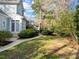 Beautiful backyard featuring a sidewalk, green grass and trimmed bushes at 5413 Leopards Bane Ct, Holly Springs, NC 27540