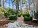 Landscaped backyard with walkway and manicured bushes and garden at 5413 Leopards Bane Ct, Holly Springs, NC 27540