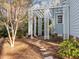 Backyard patio area featuring a charming pergola, stone pavers, and established landscaping at 5413 Leopards Bane Ct, Holly Springs, NC 27540
