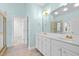 Bathroom with double vanity, tile floor, and walk-in closet access at 5413 Leopards Bane Ct, Holly Springs, NC 27540