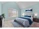 Stylishly decorated bedroom featuring a vaulted ceiling and a large window for natural light at 5413 Leopards Bane Ct, Holly Springs, NC 27540