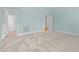 Spacious bedroom with neutral carpet and three doors leading to various rooms at 5413 Leopards Bane Ct, Holly Springs, NC 27540