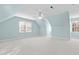 Bright bedroom featuring a ceiling fan, light blue walls, and dormer windows at 5413 Leopards Bane Ct, Holly Springs, NC 27540
