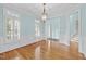 Bright dining room with hardwood floors, wainscoting, and a stylish chandelier at 5413 Leopards Bane Ct, Holly Springs, NC 27540